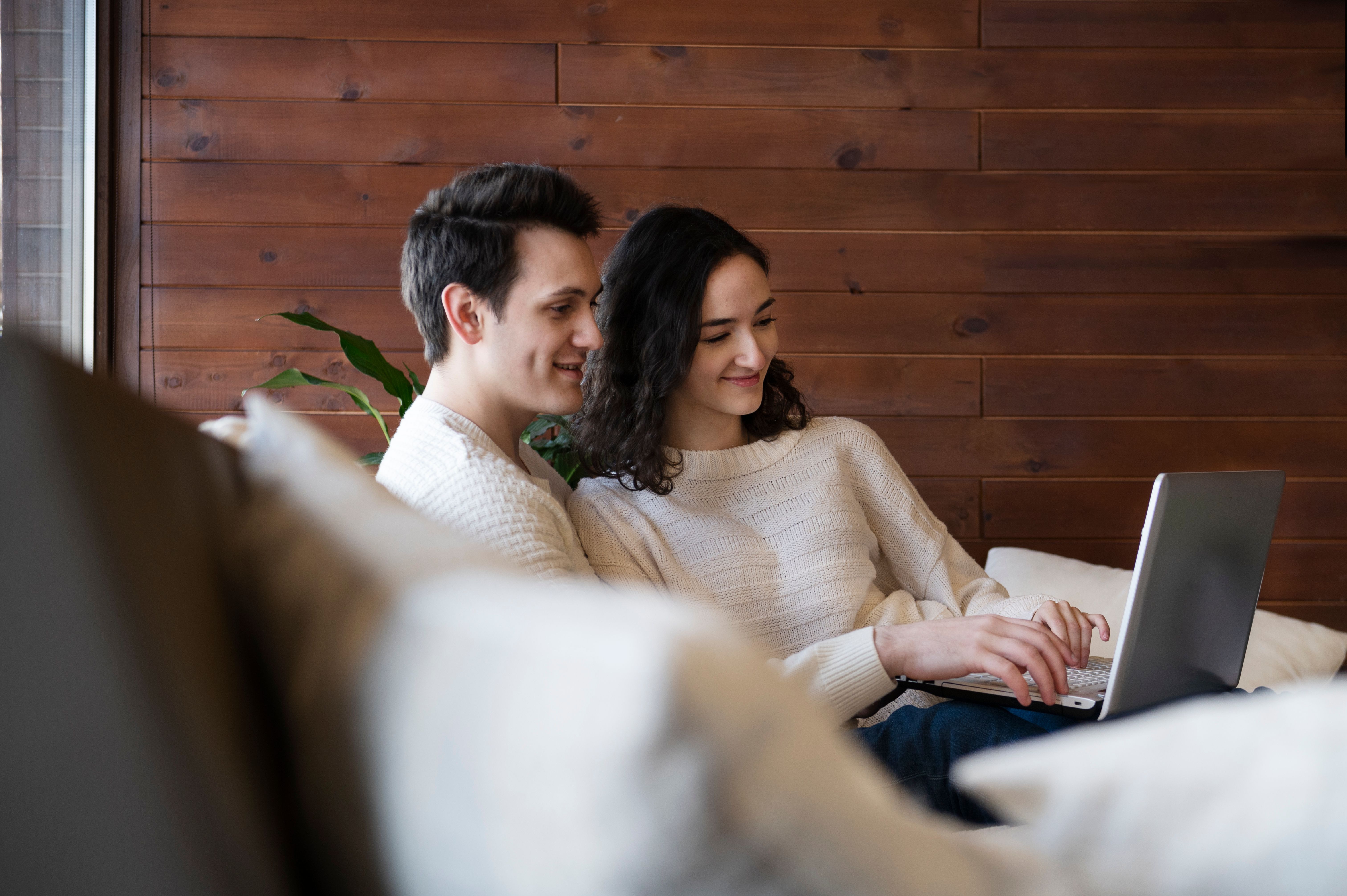 Medium shot smiley couple with laptop